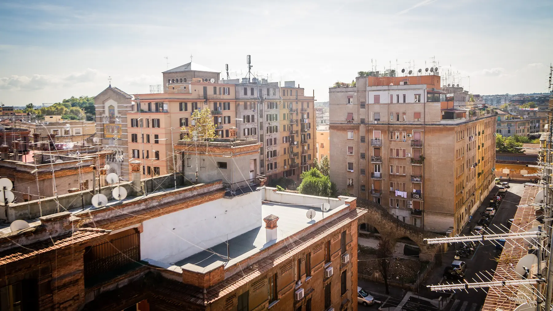 A view over Testaccio's rooftops and apartment blocks in warm daylight.